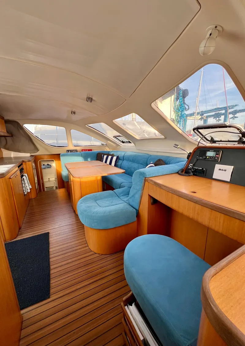 Slide: The Image of Interior of 2003 Catana 431 catamaran with blue seating and wooden accents. - 44