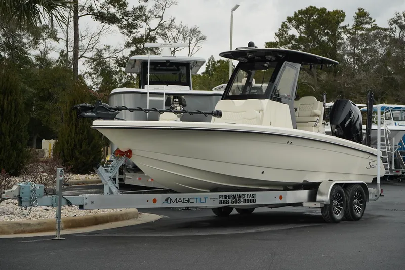 The Image of 2025 Scout 261 XSS boat on trailer, parked outdoors. - 0