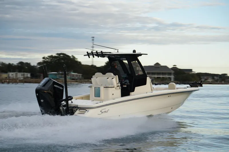 Slide: The Image of 2025 Scout 261 XSS boat cruising on water, side view. - 21