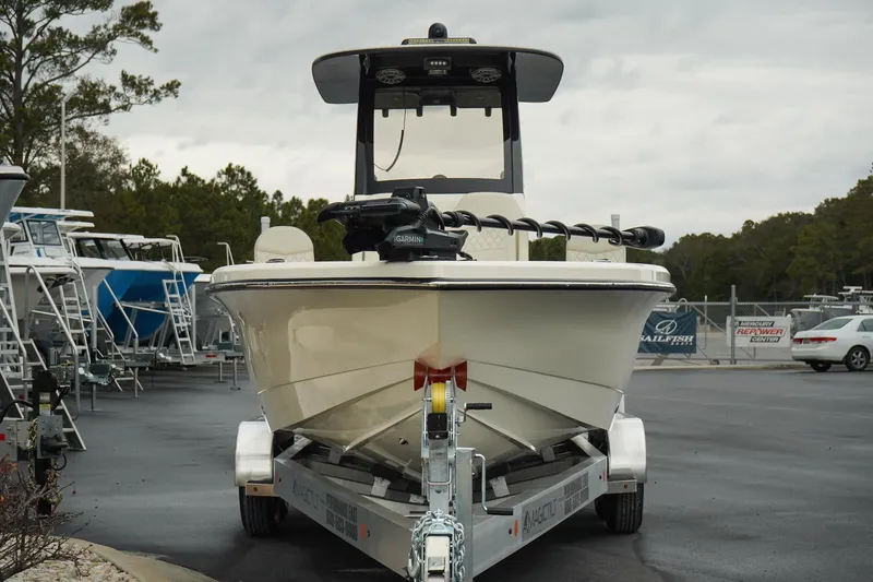 Slide: The Image of 2025 Scout 261 XSS boat on trailer in marina setting. - 24