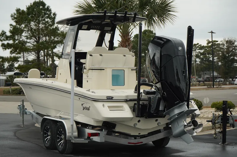 Slide: The Image of 2025 Scout 261 XSS boat on trailer, rear view, parked outdoors. - 27