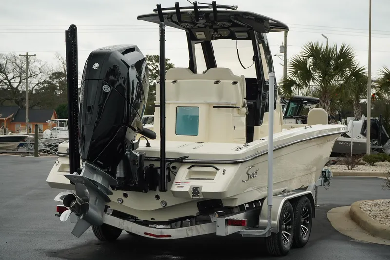Slide: The Image of 2025 Scout 261 XSS boat on trailer, rear view with outboard motor. - 28