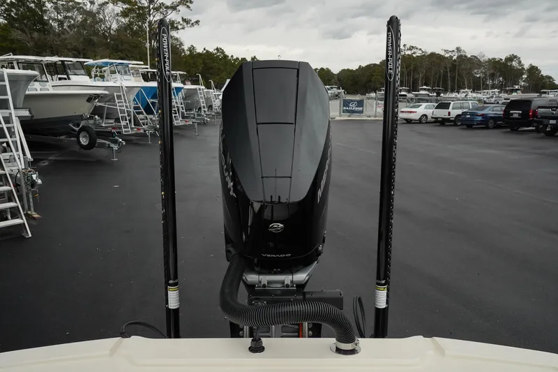 Slide: The Image of 2025 Scout 261 XSS boat engine at a marina, surrounded by parked boats and vehicles. - 29