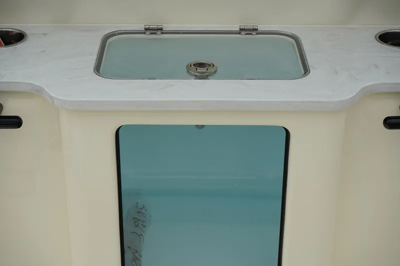 Slide: The Image of 2025 Scout 261 XSS boat interior with a sleek countertop and built-in sink. - 32