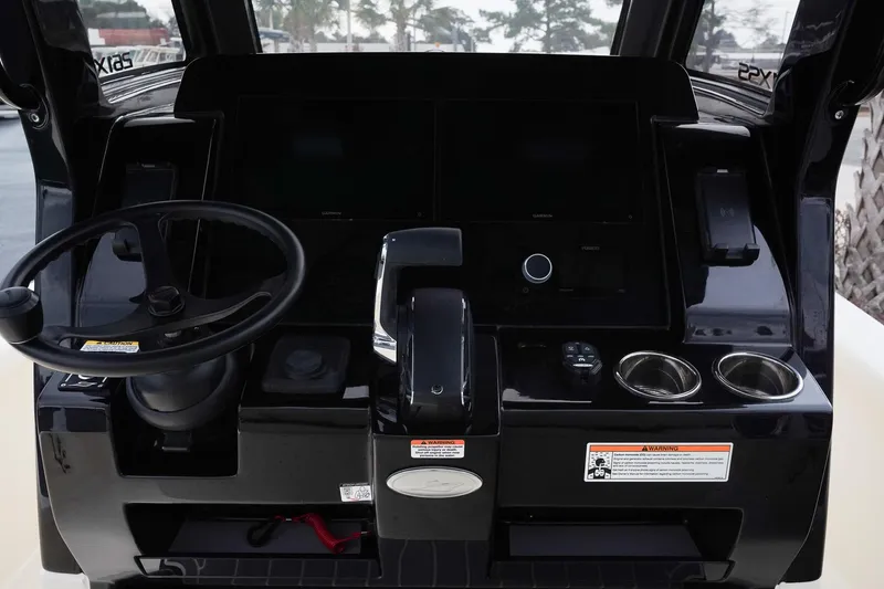 Slide: The Image of 2025 Scout 261 XSS boat dashboard with steering wheel and controls. - 33