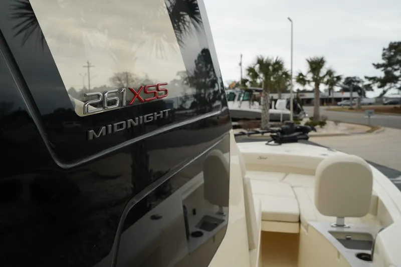 Slide: The Image of 2025 Scout 261 XSS boat, close-up of "Midnight" model name on sleek exterior. - 35