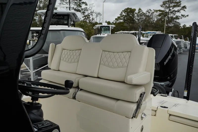 Slide: The Image of 2025 Scout 261 XSS boat interior with beige seating and steering wheel. - 39
