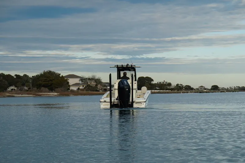 Slide: The Image of 2025 Scout 261 XSS boat cruising on calm water under a cloudy sky. - 9