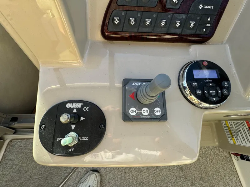 Slide: The Image of Control panel of a 2008 Sea Ray 310 Sundancer boat with switches and joystick. - 19
