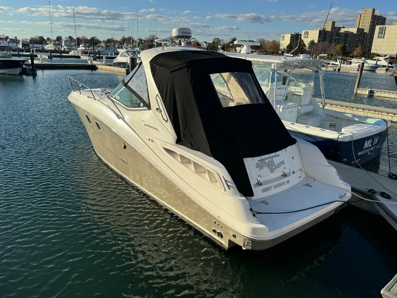Slide: The Image of 2008 Sea Ray 310 Sundancer docked at marina, rear view with black canopy. - 3
