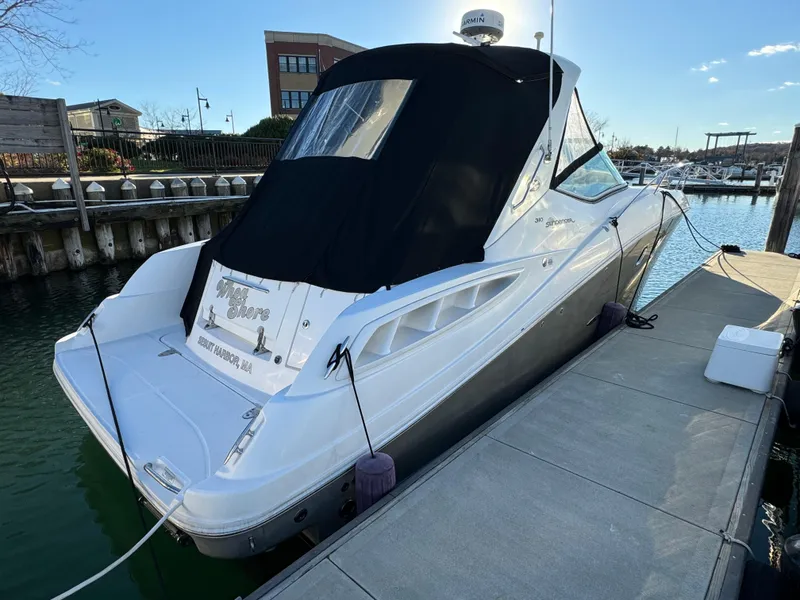 Slide: The Image of 2008 Sea Ray 310 Sundancer docked at marina with black cover. - 6