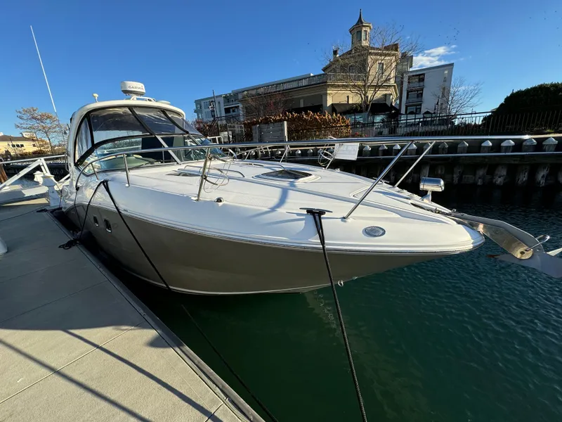 Slide: The Image of 2008 Sea Ray 310 Sundancer docked in a marina, clear blue sky. - 7
