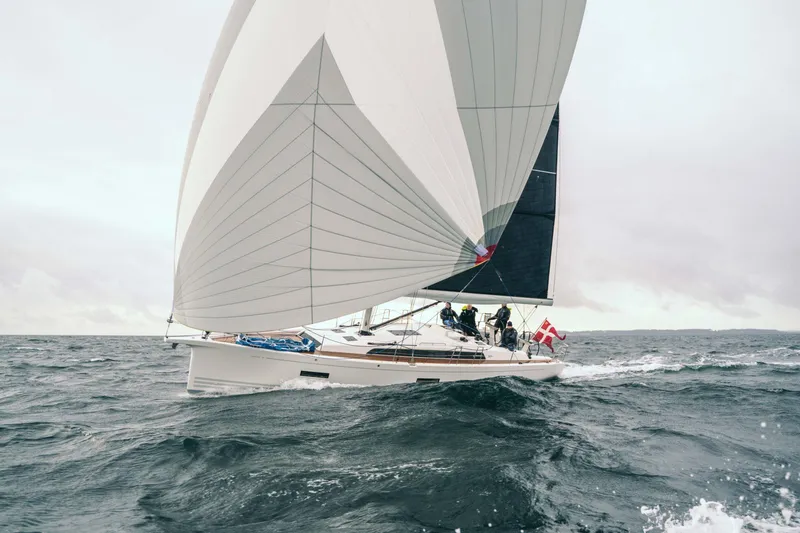 The Image of 2026 X-Yachts X4 3 sailing on open sea with large sails and crew onboard. - 0