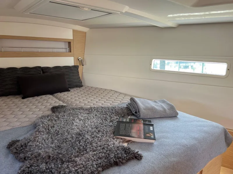 Slide: The Image of Luxurious cabin interior of 2026 X-Yachts X4 3 with cozy bedding and reading material. - 14