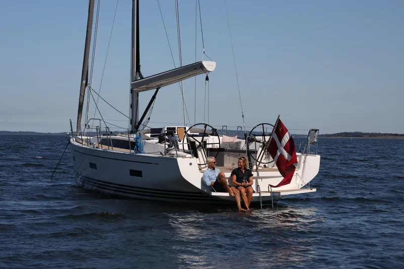 Slide: The Image of 2026 X-Yachts X4 3 sailboat with two people, Danish flag, calm sea. - 3