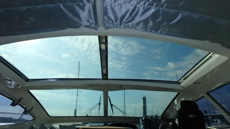 Slide: The Image of Interior view of 2006 Azimut Atlantis 55 yacht with panoramic sunroof and clear sky. - 7