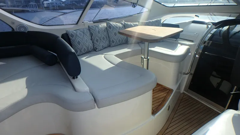 Slide: The Image of Luxurious interior of 2006 Azimut Atlantis 55 yacht with plush seating and wooden table. - 8