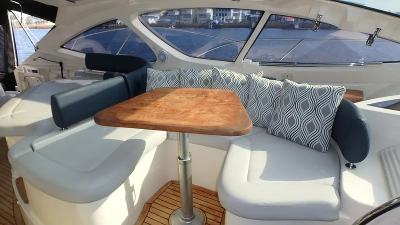 Slide: The Image of Luxurious seating area on 2006 Azimut Atlantis 55 yacht with elegant cushions and wooden table. - 9