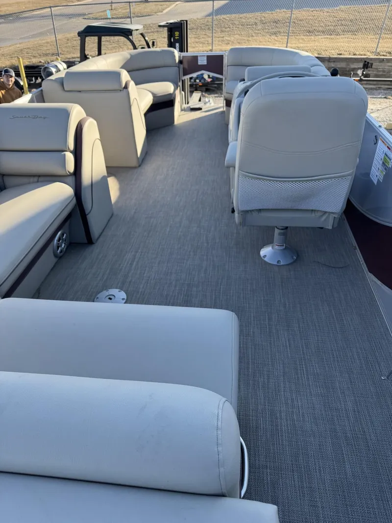 Slide: The Image of 2020 South Bay 521 CR pontoon boat interior with beige seating and carpeted floor. - 3