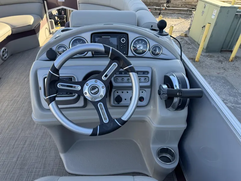 Slide: The Image of Steering console of 2020 South Bay 521 CR pontoon boat with modern controls. - 4