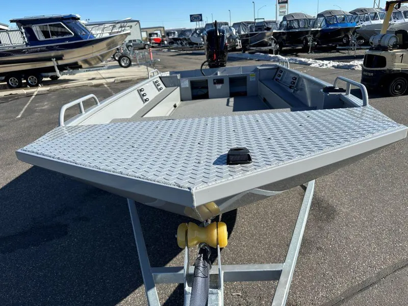 Slide: The Image of 2025 Smoker Craft Sportsman Pro 1866 boat on trailer, displayed in a dealership lot. - 2