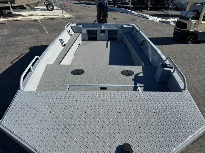 Slide: The Image of 2025 Smoker Craft Sportsman Pro 1866 boat, spacious deck, parked outdoors. - 3