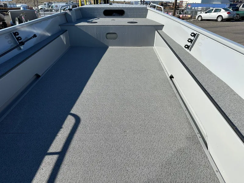 Slide: The Image of 2025 Smoker Craft Sportsman Pro 1866 boat interior, spacious deck, gray flooring, fishing rod holders. - 5