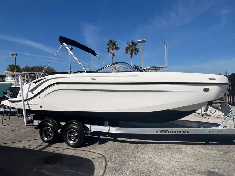 The Image of 2021 Bayliner DX 2200 boat on trailer, sunny day, palm trees in background. - 0