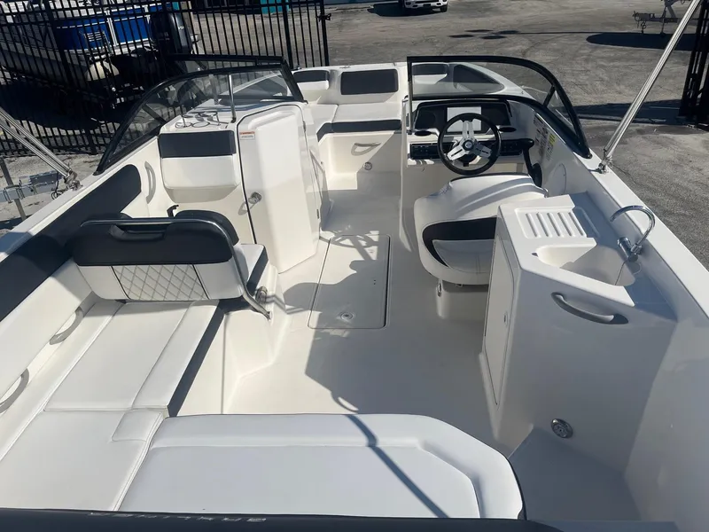 Slide: The Image of 2021 Bayliner DX 2200 boat interior with seating and steering wheel. - 5