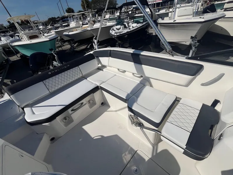 Slide: The Image of 2021 Bayliner DX 2200 boat interior with spacious seating and modern design. - 8