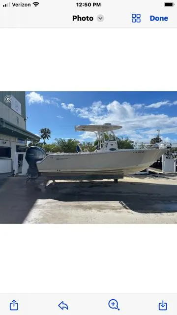 Slide: The Image of 2016 Sportsman HERITAGE 252 boat on display under a clear blue sky. - 3