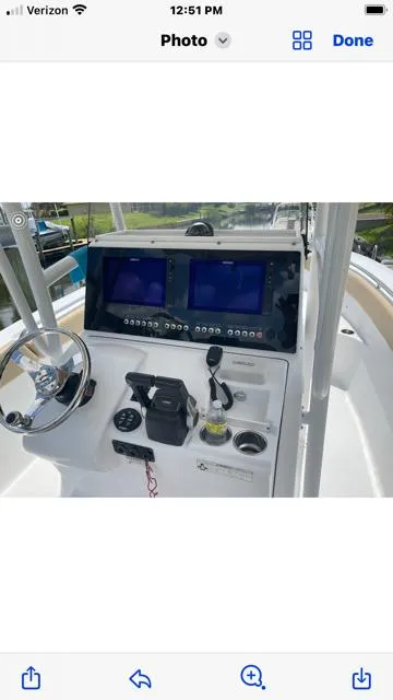 Slide: The Image of 2016 Sportsman HERITAGE 252 boat dashboard with dual screens and steering wheel. - 8