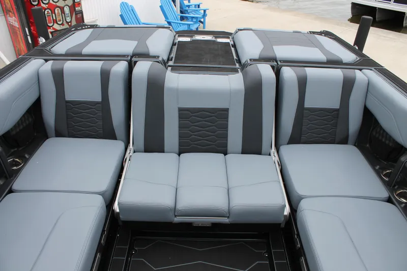 Slide: The Image of 2025 Malibu 23 MXZ boat interior with gray and black seating, showcasing modern design. - 5