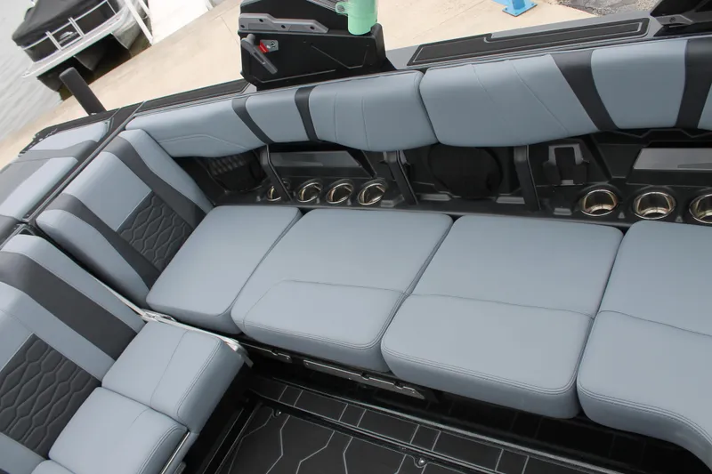 Slide: The Image of 2025 Malibu 23 MXZ boat interior with sleek gray seating and modern design. - 6