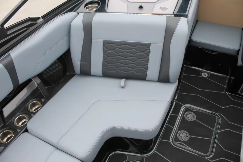 Slide: The Image of 2025 Malibu 23 MXZ boat interior with sleek gray seating and modern design. - 7