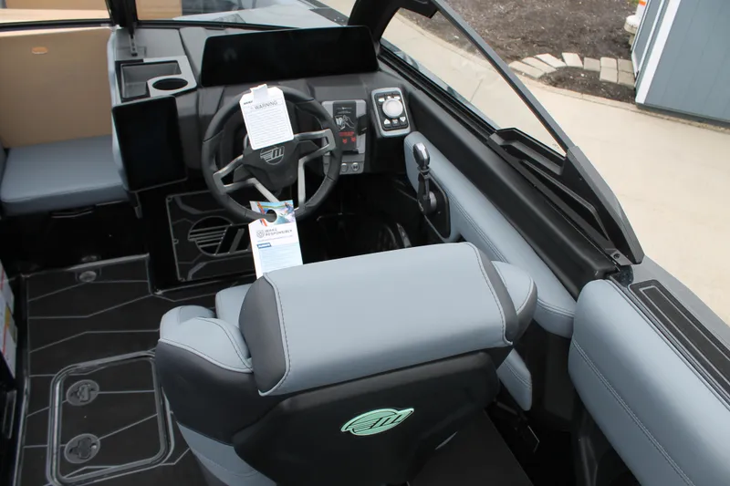 Slide: The Image of Interior of 2025 Malibu 23 MXZ boat with modern steering and seating. - 8