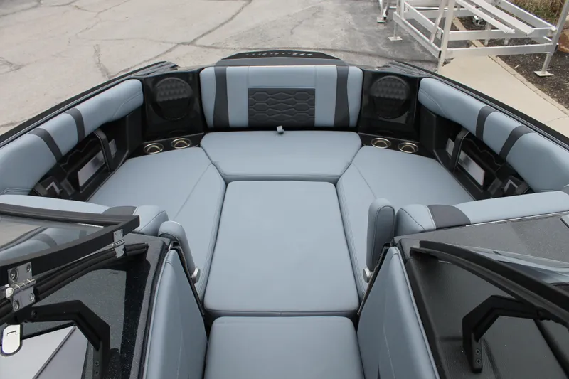 Slide: The Image of 2025 Malibu 23 MXZ boat interior with luxurious gray seating and modern design. - 9