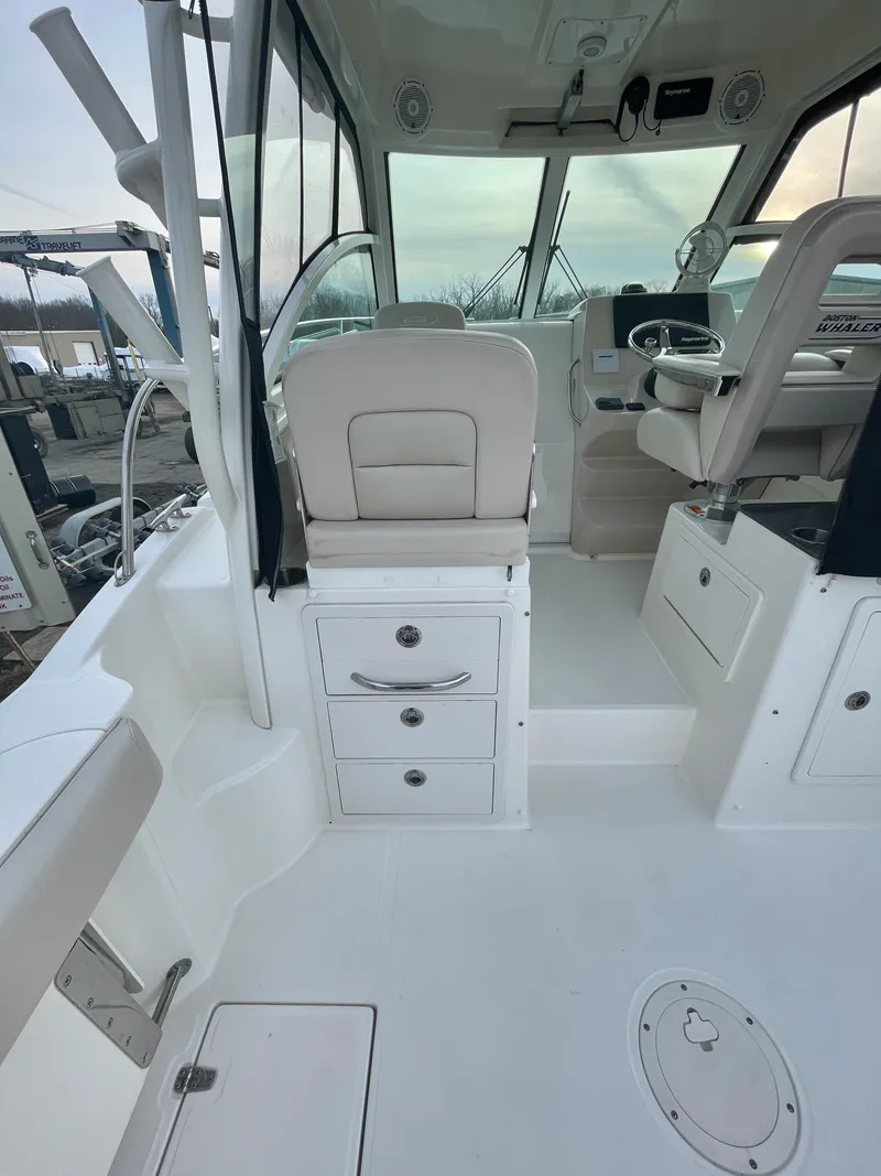 Slide: The Image of 2022 Boston Whaler 285 Conquest interior with seating and storage. - 10