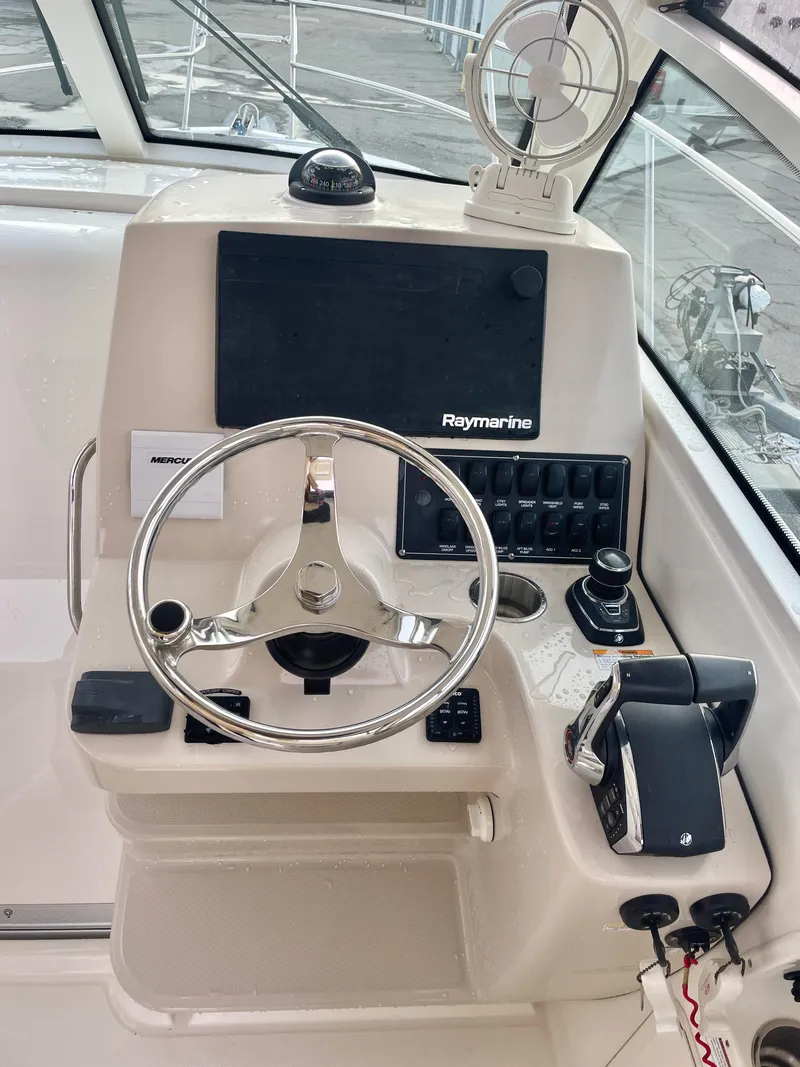 Slide: The Image of 2022 Boston Whaler 285 Conquest helm with Raymarine electronics and modern controls. - 14