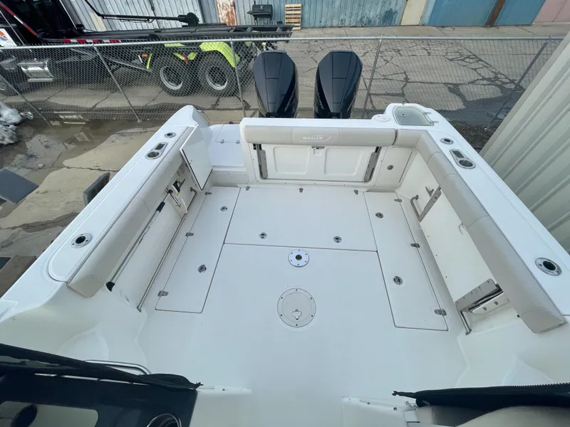 Slide: The Image of 2022 Boston Whaler 285 Conquest boat deck, spacious seating, dual engines, and storage compartments. - 7