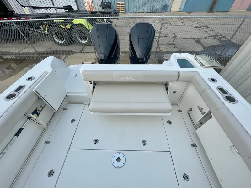 Slide: The Image of 2022 Boston Whaler 285 Conquest boat deck with dual engines and seating area. - 8