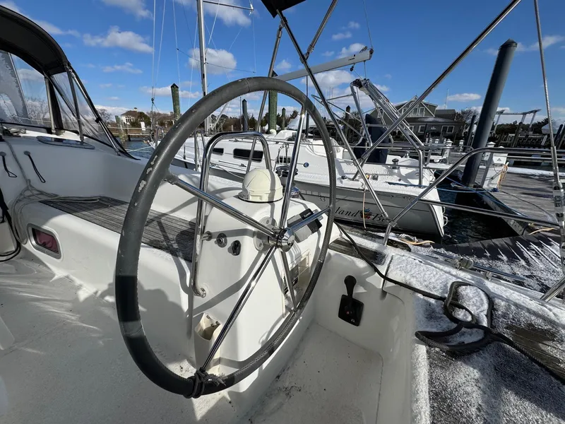Slide: The Image of Steering wheel of a 2012 Beneteau 40 sailboat docked at a marina. - 11