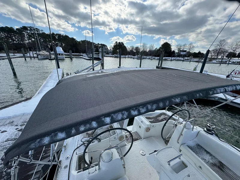 Slide: The Image of Beneteau 40 sailboat, 2012 model, docked in snowy marina with overcast sky. - 12