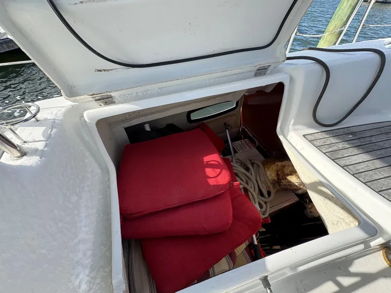 Slide: The Image of Storage compartment on a 2012 Beneteau 40 sailboat with red cushions and ropes. - 15