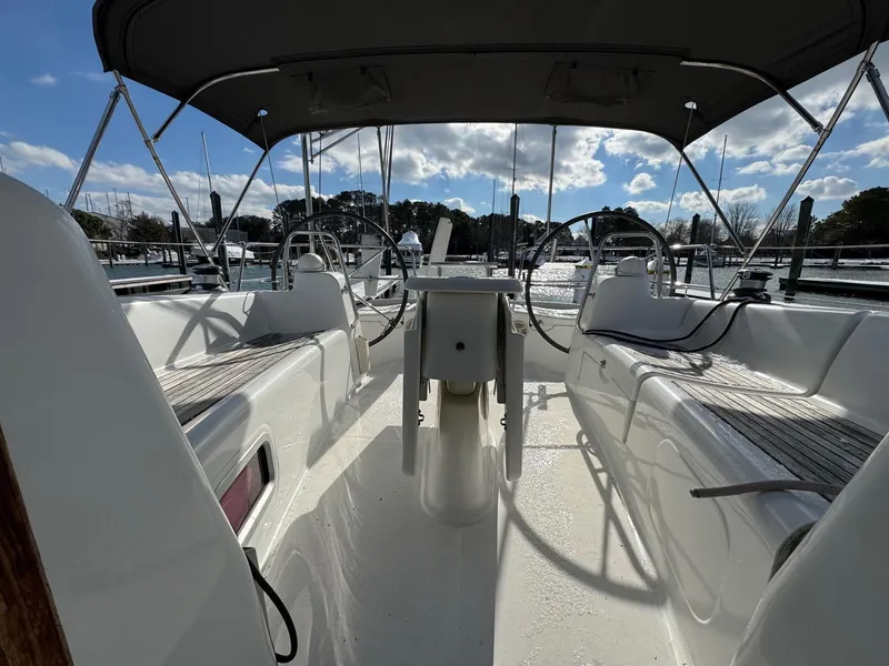 Slide: The Image of 2012 Beneteau 40 sailboat cockpit with dual steering wheels and canopy. - 16