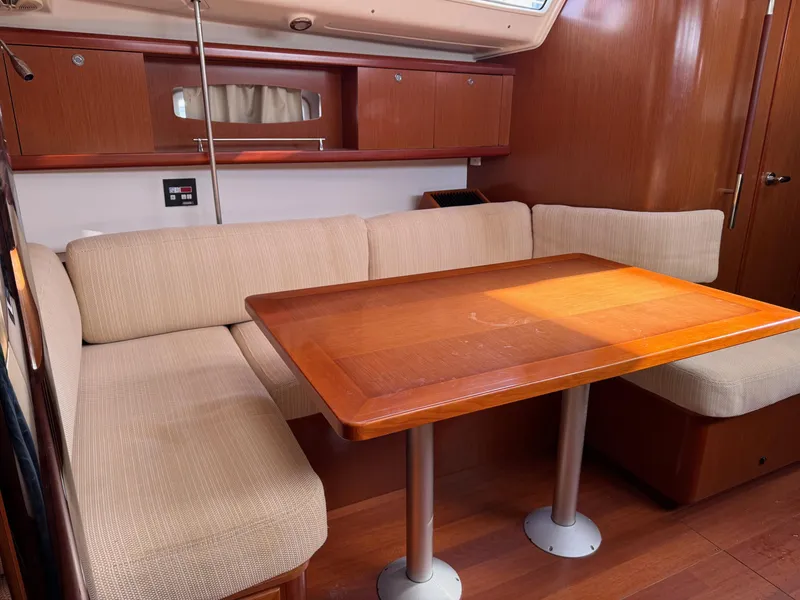 Slide: The Image of Interior of 2012 Beneteau 40 yacht with wooden table and beige seating. - 19