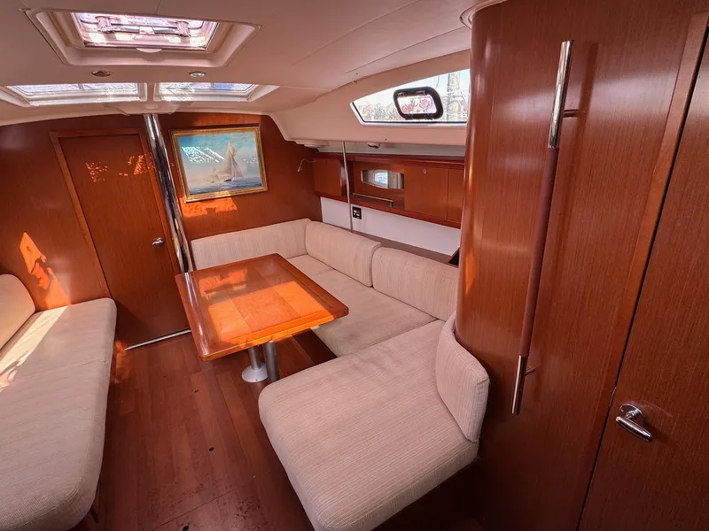 Slide: The Image of Interior of 2012 Beneteau 40 sailboat with wood finish and cozy seating area. - 20