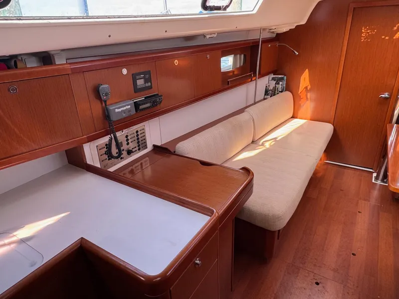 Slide: The Image of Interior of 2012 Beneteau 40 yacht with wooden cabinetry and beige seating. - 22