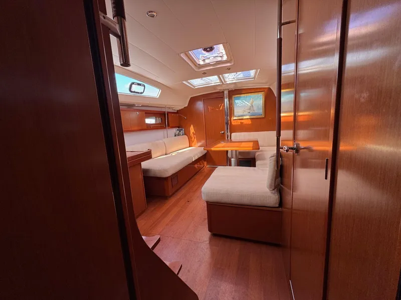 Slide: The Image of Interior of 2012 Beneteau 40 yacht with wooden finish and comfortable seating. - 24