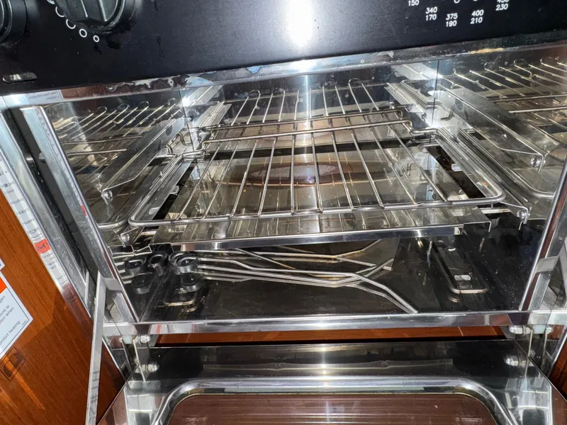 Slide: The Image of Stainless steel oven interior on 2012 Beneteau 40 yacht, featuring multiple racks and temperature controls. - 29